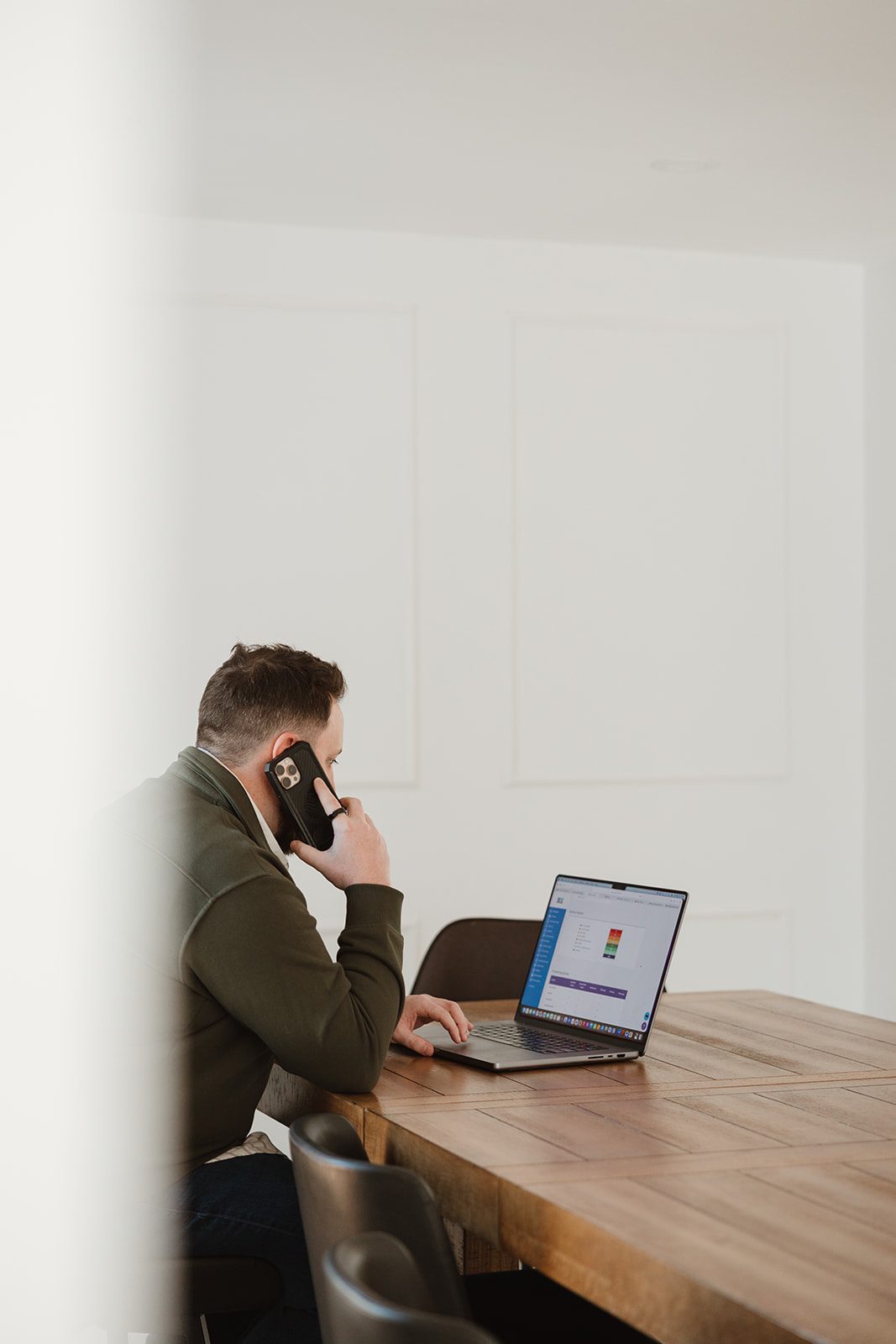 Founder on a call at the table