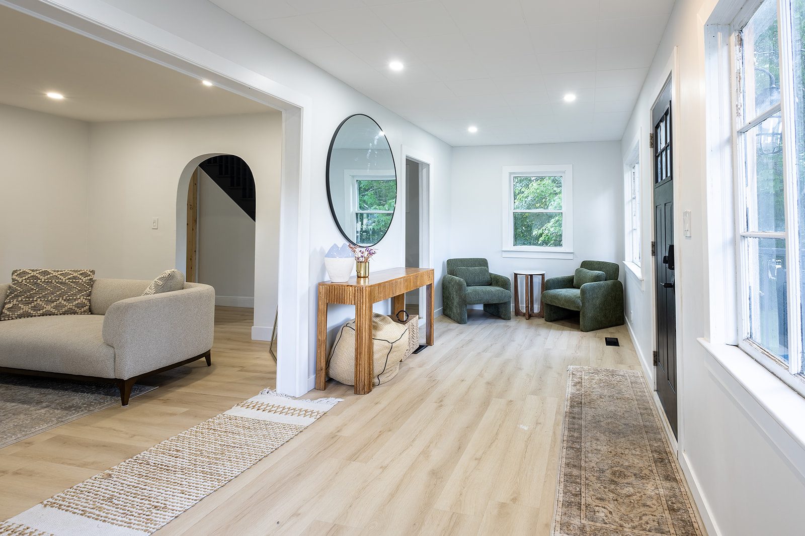 Entryway with round mirror and console table
