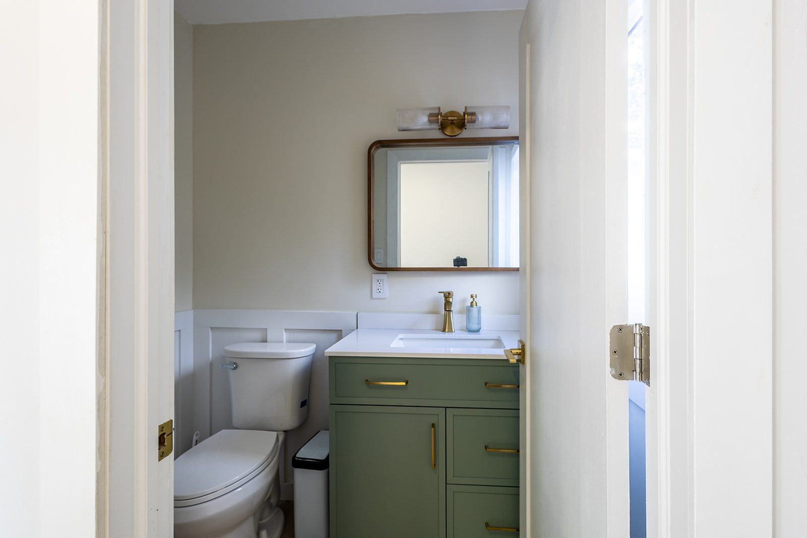 Powder room with green vanity